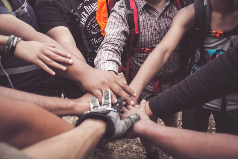 Many Hands in Huddle